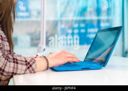 Girl typing text on laptop Stock Photo