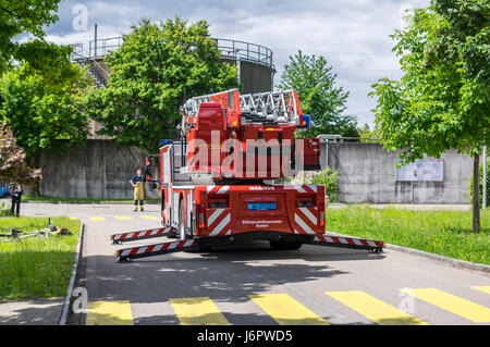 Rear view of an Iveco Magirus 160E30 turntable ladder truck of a Swiss fire brigade. Outriggers/jacks extended, but ladder still retracted.