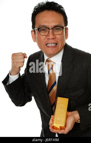 wealth gold bar gold finances bank lending institution fist wealth leader Stock Photo