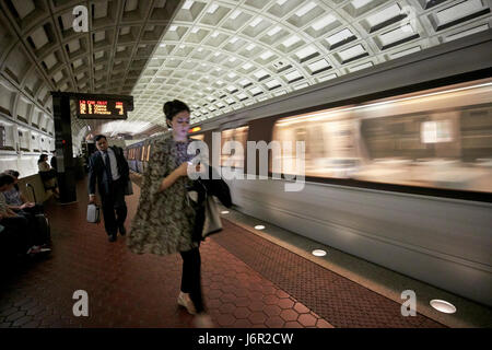 passengers and moving train at smithsonian metro underground train system Washington DC USA deliberate motion blur Stock Photo