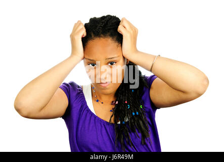 An alternative looking girl standing in a studio wearing a band