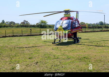 Midlands Air Ambulance lands in a field on a emergency call Stock Photo