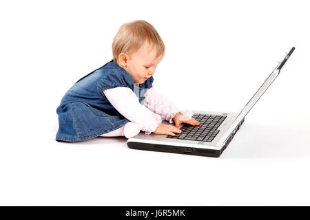 friendly kind baby put sitting sit computer work work job labor child girl Stock Photo