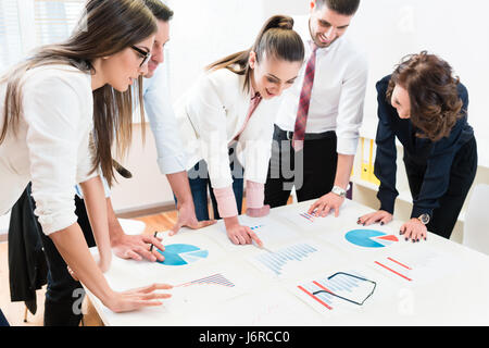Financial consultants in bank analyzing data Stock Photo