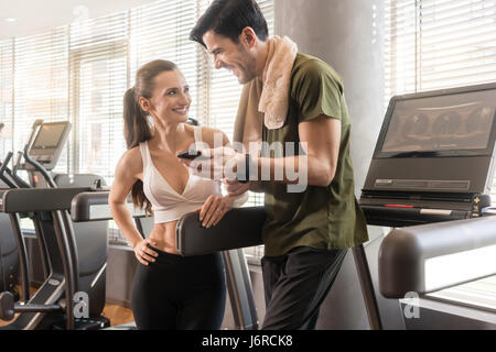 Young couple smiling while communicating on the mobile phone dur Stock Photo