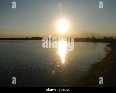 This image shows the fish ponds along San Nicolas Poblacion Boulevard in Minalin, Pampanga, Philippines. The area is known for its agricultural activity, particularly fish farming, contributing to local industry and economy. Stock Photo