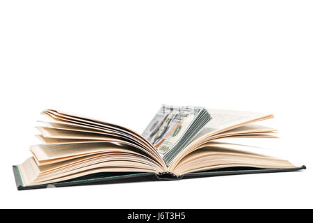 Open book with a stack of dollars lying in it, isolated on a white background Stock Photo