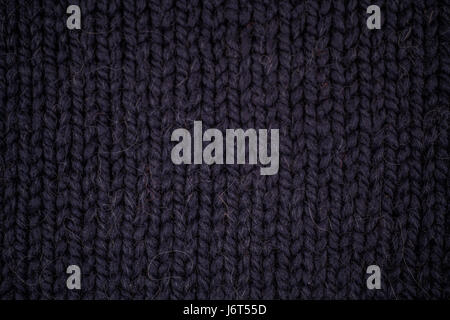 Texture of dark blue knitted woolen fabric closeup Stock Photo