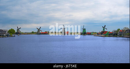 Panorama of Zaanse Schans windmills and water channel, North Holland, Netherlands, Europe. Panoramic view of dutch mills in famous authentic village,  Stock Photo