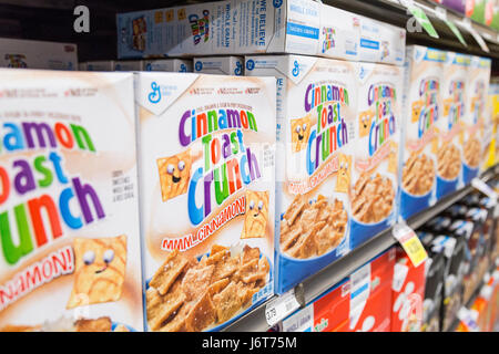 boxes of Cinnamon Toast Crunch cereal on shelves at a grocery store Stock Photo