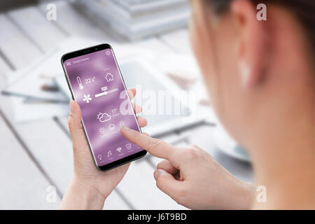 Woman use smart home control app on mobile phone. Stock Photo