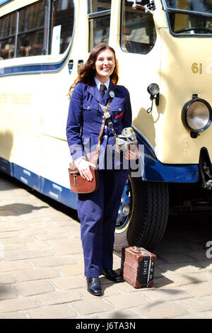 A young woman dresses up as a bus conductor for Haworth's 1940s weekend in Yorkshire.
