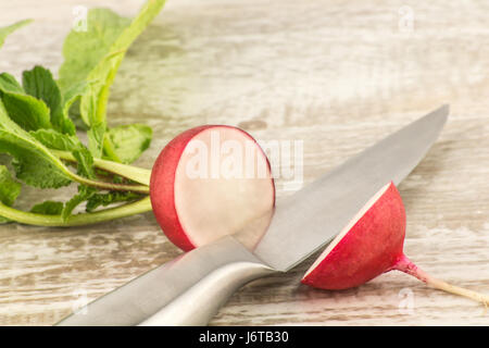 Juicy fresh radish in a cut on a white wooden background close up Stock Photo
