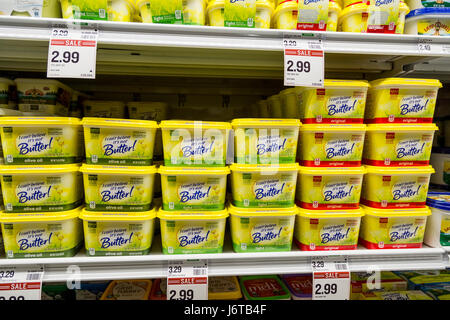 tubs of I Can't Believe its Not Butter brand non dairy spread in the refrigerator section of a grocery store Stock Photo