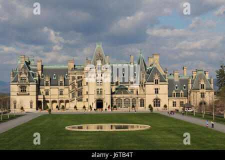 Biltmore House at the Biltmore Mansion in Asheville, North Carolina.  Sun on the house and clouds in the sky. Stock Photo