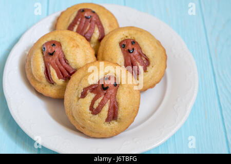 Kid funny food. Cornbread corn dogs muffins with cute octopus sausage snack Stock Photo