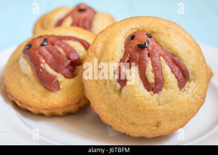 Kid funny food. Cornbread corn dogs muffins with cute octopus sausage snack Stock Photo