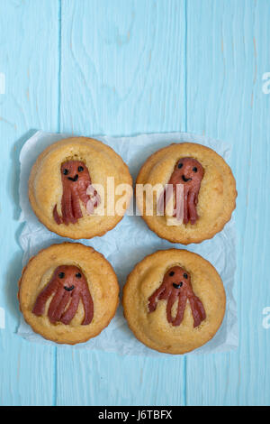 Kid funny food. Cornbread corn dogs muffins with cute octopus sausage snack Stock Photo