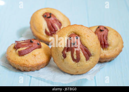 Kid funny food. Cornbread corn dogs muffins with cute octopus sausage snack Stock Photo