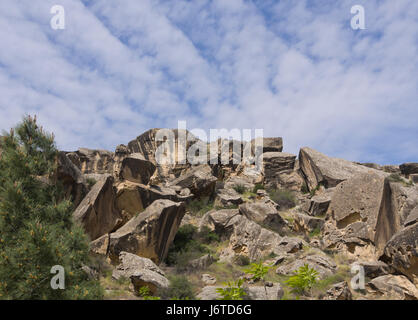 Gobustan National Park one hour south of Baku in Azerbaijan, offers stunning landscapes and 6000 ancient petroglyphs, weird rocks, sun and sky Stock Photo