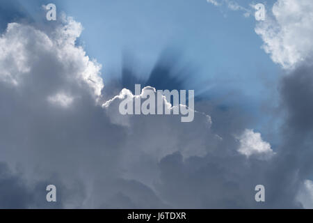 Sunbeam radiating from behind the cloud Stock Photo