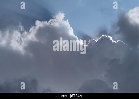 Sunbeam radiating from behind the cloud Stock Photo