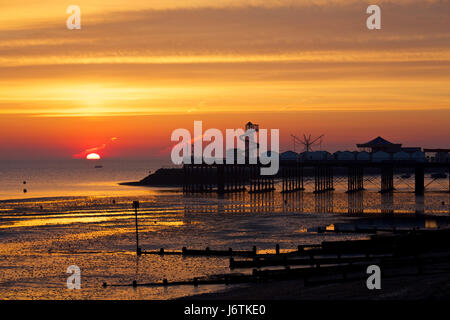 Herne Bay, Kent, UK. 22nd May 2017: UK Weather. Sunrise at Herne Bay pier as contrails out at sea can be seen, caught in the early morning light at low tide. The coming week is set to see the highest temperatures this year with 27C predicted, and people are expected to head to the seaside helter skelter and amusements on Herne Bay seafront. Credit: Alan Payton/Alamy Live News Stock Photo