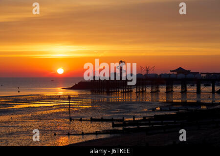 Herne Bay, Kent, UK. 22nd May 2017: UK Weather. Sunrise at Herne Bay pier at low tide. The coming week is set to see the highest temperatures this year with 27C predicted, and people are expected to head to the seaside helter skelter and amusements on Herne Bay seafront. Credit: Alan Payton/Alamy Live News Stock Photo