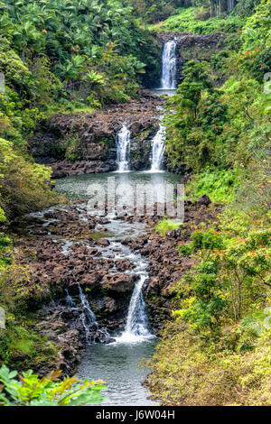A vibrant image of Umauma Falls in Hawaii shows the three tier cascade of a beautiful natural wonder Stock Photo