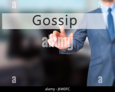 Gossip - Businessman hand pressing button on touch screen interface. Business, technology, internet concept. Stock Photo Stock Photo