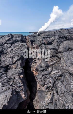 A long volcanic surface fissure formed from Kilauea volcano in Hawaii shows the devastation eruptions cause. Stock Photo