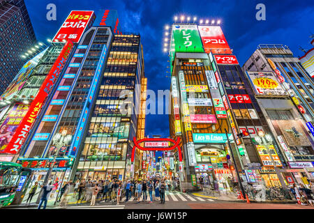 TOKYO, JAPAN - MAY 7, 2017: Crowds pass through Kabukicho in the Shinjuku district. The area is an entertainment and red-light district. Stock Photo