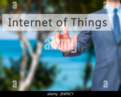 Internet of Things - Businessman hand pressing button on touch screen interface. Business, technology, internet concept. Stock Photo Stock Photo