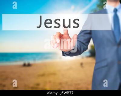 Jesus - Businessman hand pressing button on touch screen interface. Business, technology, internet concept. Stock Photo Stock Photo