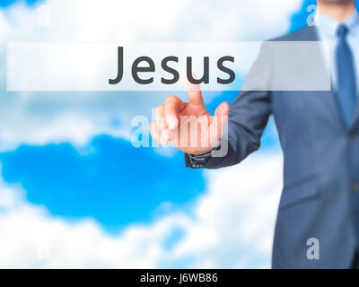 Jesus - Businessman hand pressing button on touch screen interface. Business, technology, internet concept. Stock Photo Stock Photo