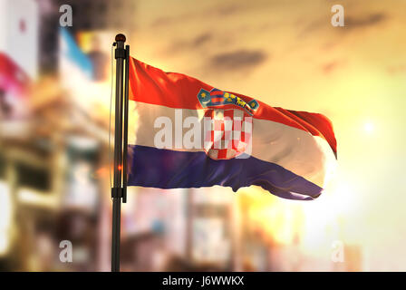 Croatia Flag Against City Blurred Background At Sunrise Backlight Stock Photo