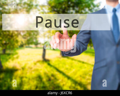 Pause - Businessman hand pressing button on touch screen interface. Business, technology, internet concept. Stock Photo Stock Photo