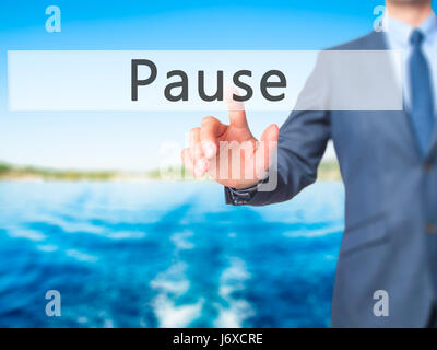 Pause - Businessman hand pressing button on touch screen interface. Business, technology, internet concept. Stock Photo Stock Photo
