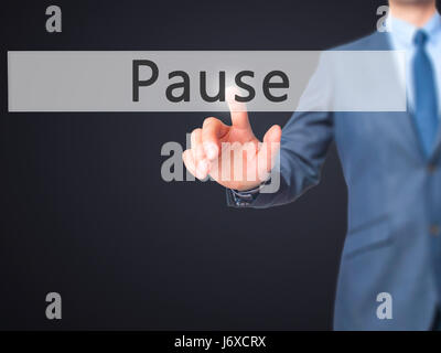 Pause - Businessman hand pressing button on touch screen interface. Business, technology, internet concept. Stock Photo Stock Photo