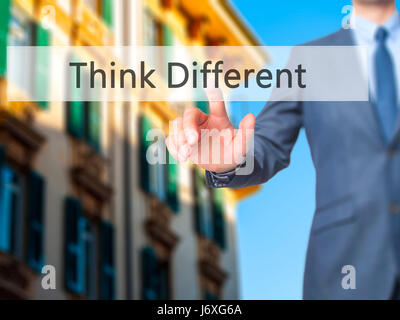 Think Different - Businessman hand touch  button on virtual  screen interface. Business, technology concept. Stock Photo Stock Photo