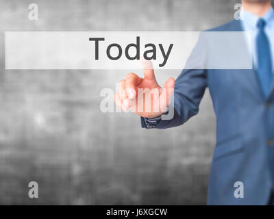 Today - Businessman click on virtual touchscreen. Business and IT concept. Stock Photo Stock Photo