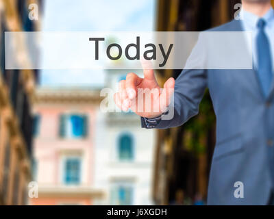 Today - Businessman click on virtual touchscreen. Business and IT concept. Stock Photo Stock Photo