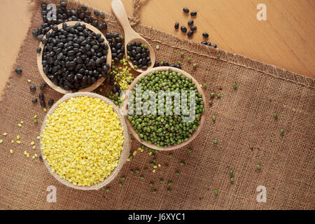 Many nuts in a bowl on wooden floor. Stock Photo