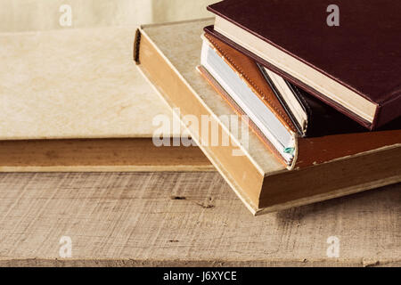 Old books put together on wooden floor. Stock Photo
