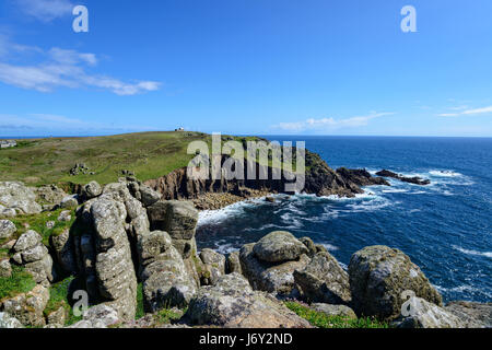 Granite rock formations on cliffs above Porth Loe cove and looking out at Gwennap Head near Porthgwarra in Cornwall Stock Photo