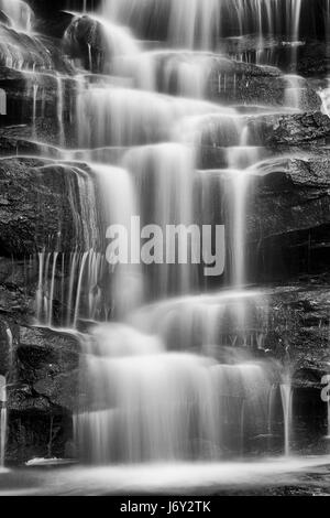 Close view of massive waterfall in a rocky creek - river falling down in smaller streams almost vertical. Somersby fall on Australia NSW central coast Stock Photo