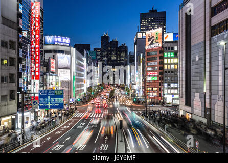 TOKYO - MAY 2, 2017: Traffic, captured with blurred motion, rushes through the busy streets of  the Shinjuku business and entertainement district at n Stock Photo