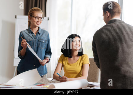 Positive friendly designers discussing a new project Stock Photo