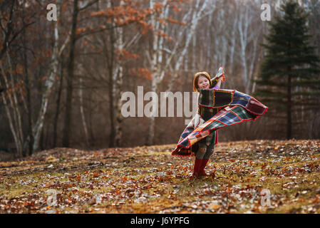 Girl wrapped in a blanket spinning around Stock Photo