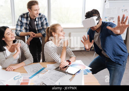 Pleasant good looking man using VR glasses Stock Photo